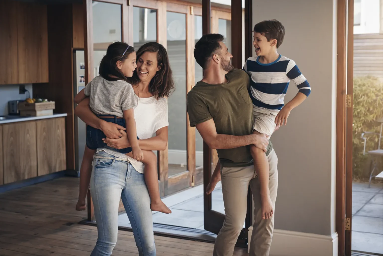 family_home_children_parents_bonding_together_fun_support_living_room_lounge_house_woman_man_kids_with_hug_playful_happiness_weekend_summer_vacation_break_1